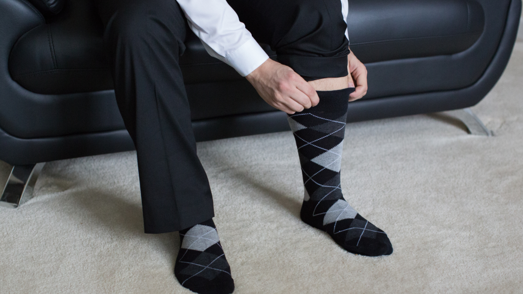 Businessman putting on dress socks